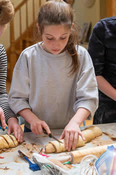 Group participant cutting chocolate babka